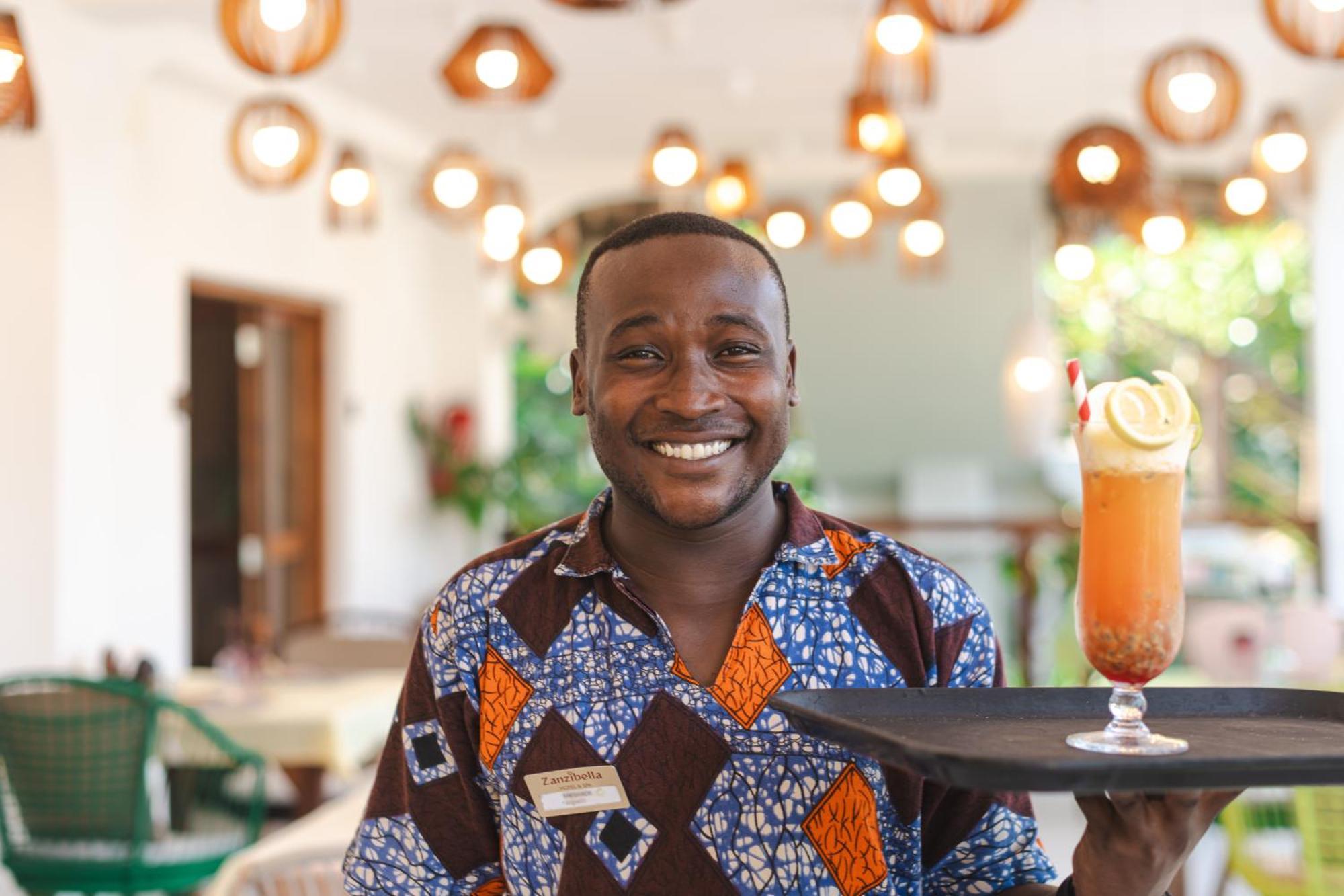 Zanzibella Hotel & Spa Kiwengwa  Extérieur photo A waiter at the Serena Hotel in Kampala, Uganda